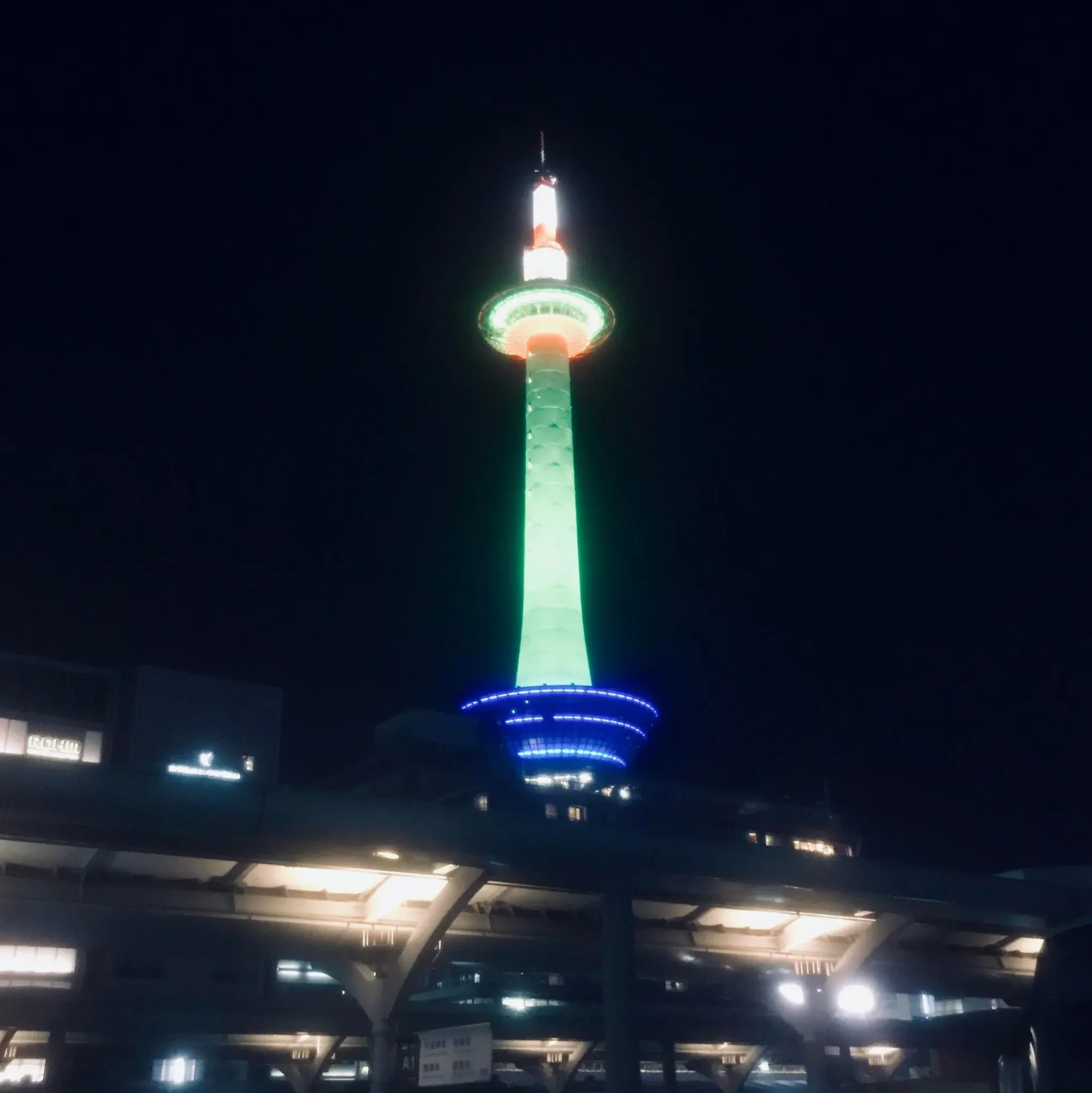 Kyoto Tower seen from in front of Kyoto Station at night